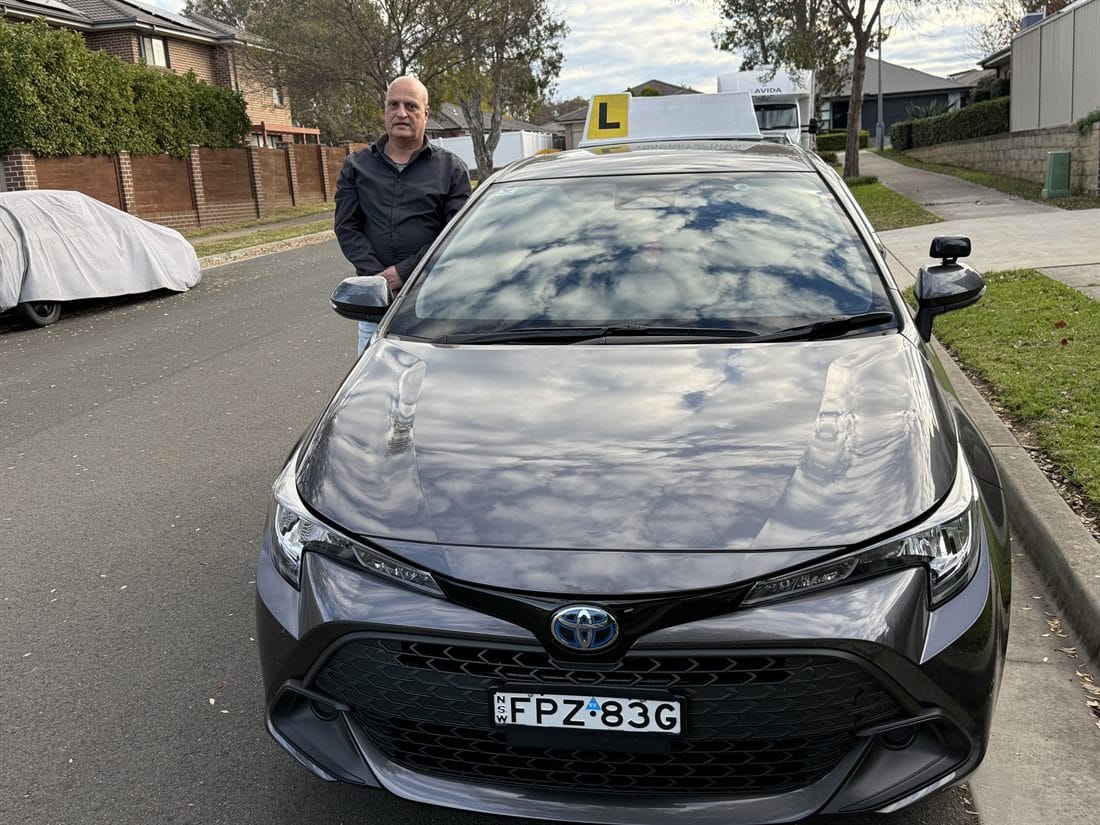 Ashraf, driving instructor in Liverpool, with his Toyota Corolla training car