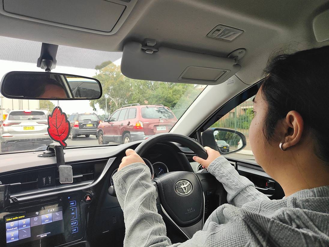 A learner driver at the wheel of an automatic training car