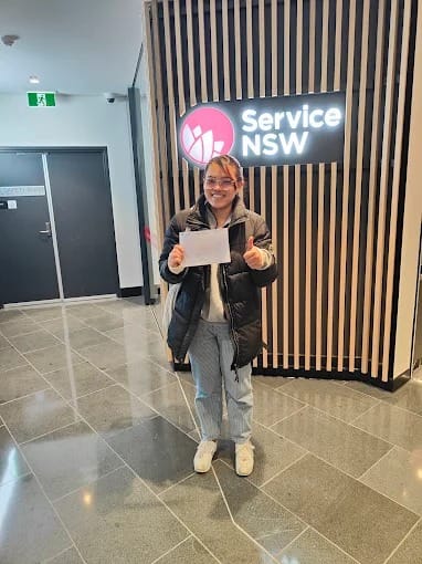 A new driver holding P plates at a Service NSW centre