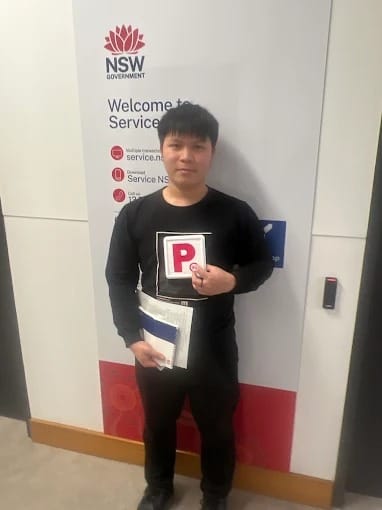A new driver holding P plates at a Service NSW centre