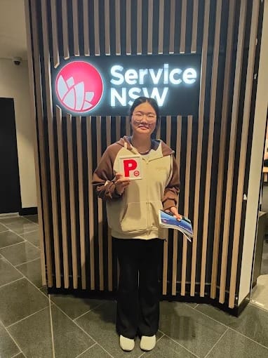A new driver holding P plates at a Service NSW centre